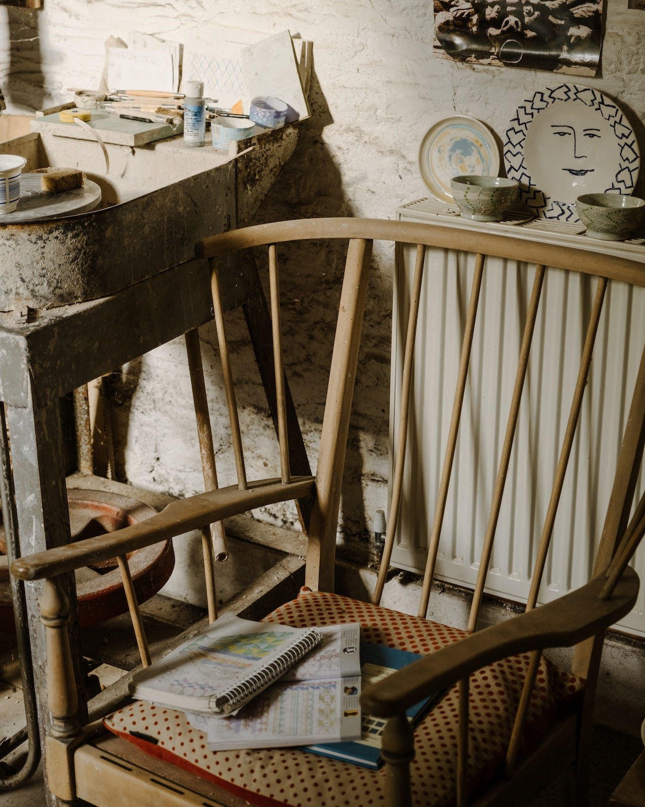 An Ercol chair from Prue's daughter-in-law with some sketchbooks from a research trip at the V&A. Prue misses spending rainy days in museums