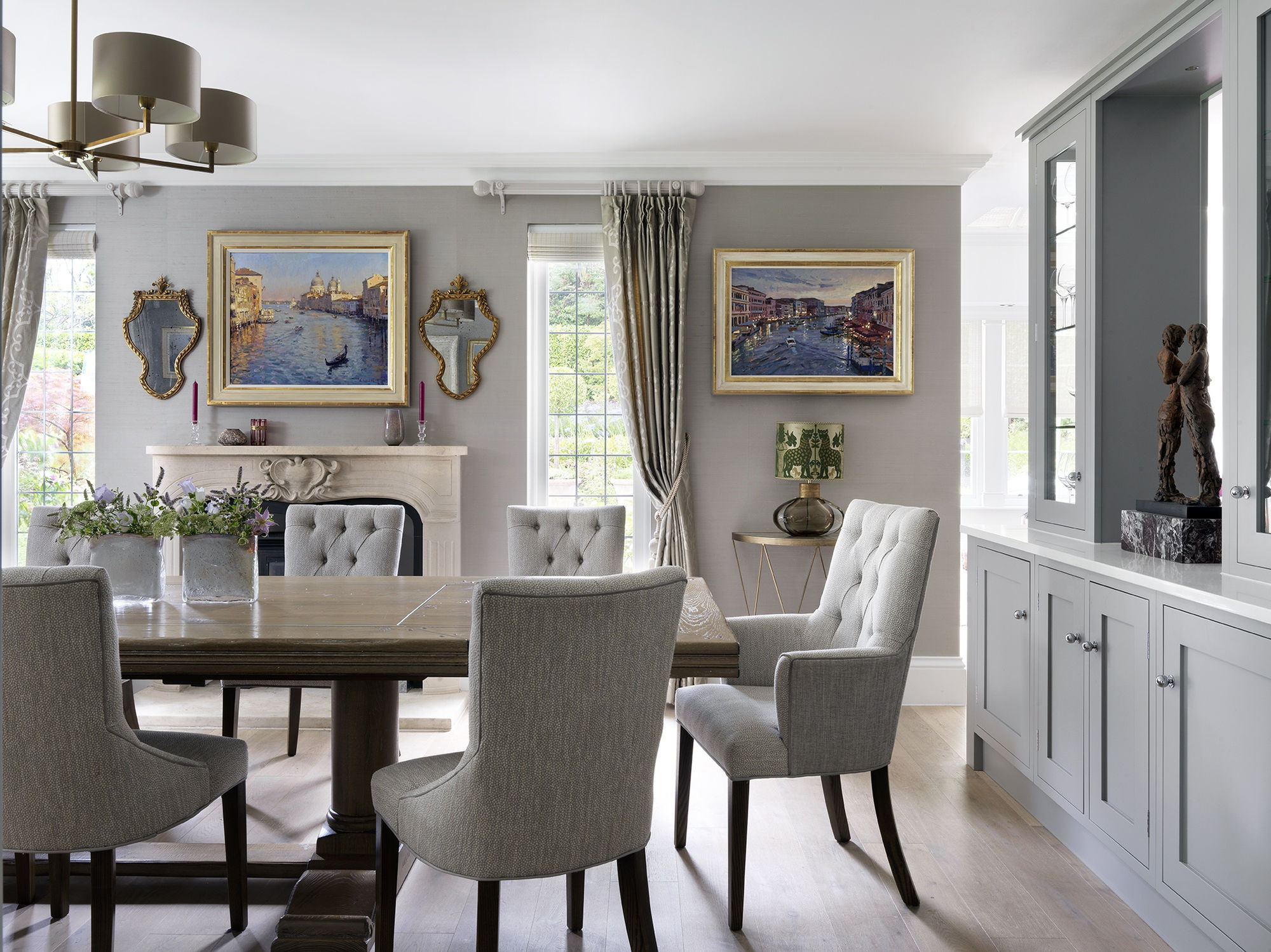 Contemporary Venetian paintings sit well in this neutral dining room scheme
