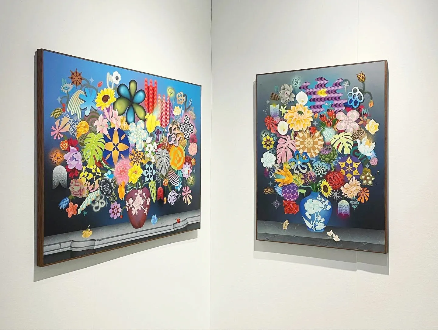 Photo of two colorful floral paintings hanging on a white wall