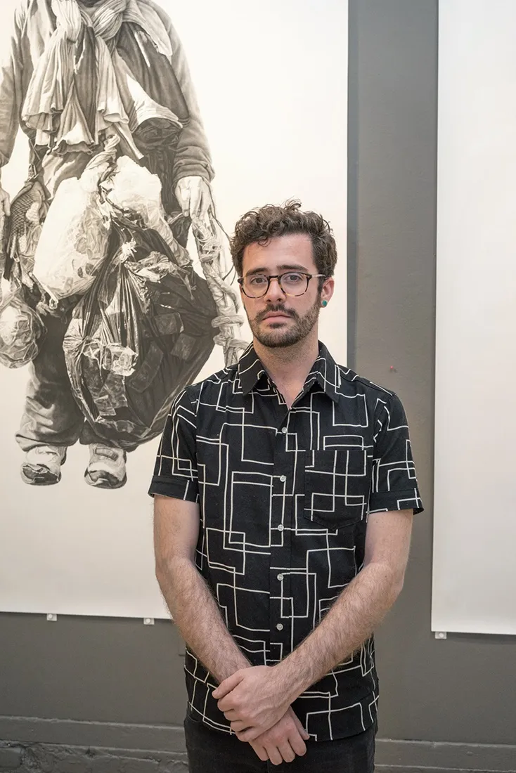Portrait of artist Joel Daniel Phillips at his exhibition "Belongings"