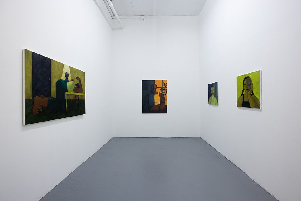 Installation photo of Hilda Palafox paintings of green women