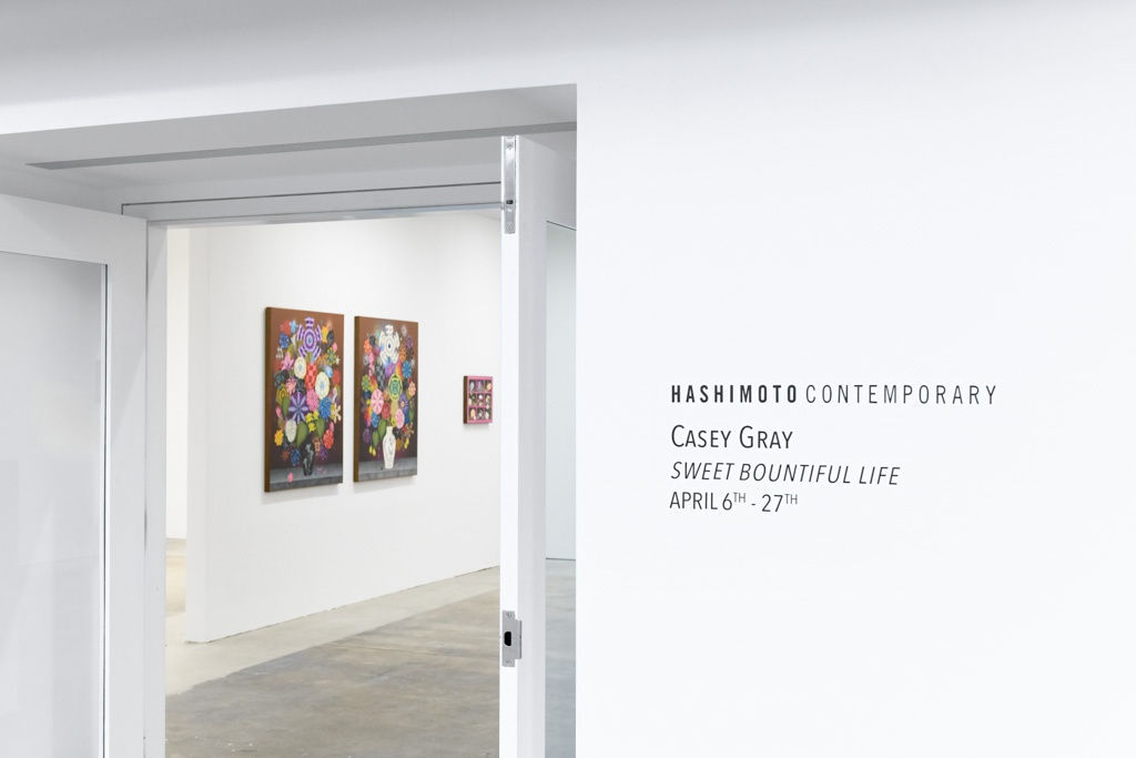 Installation photo of paintings by Casey Gray hanging on a white wall