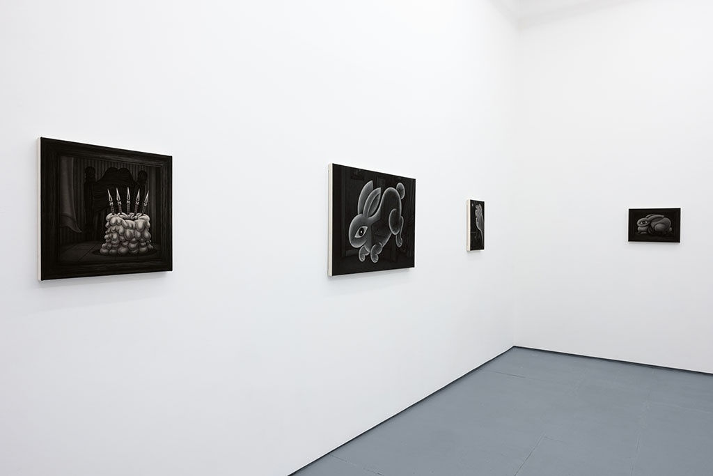 Installation view of Angela Fang Zirbes exhibition "House & Ghosts" featuring greyscale paintings on white walls