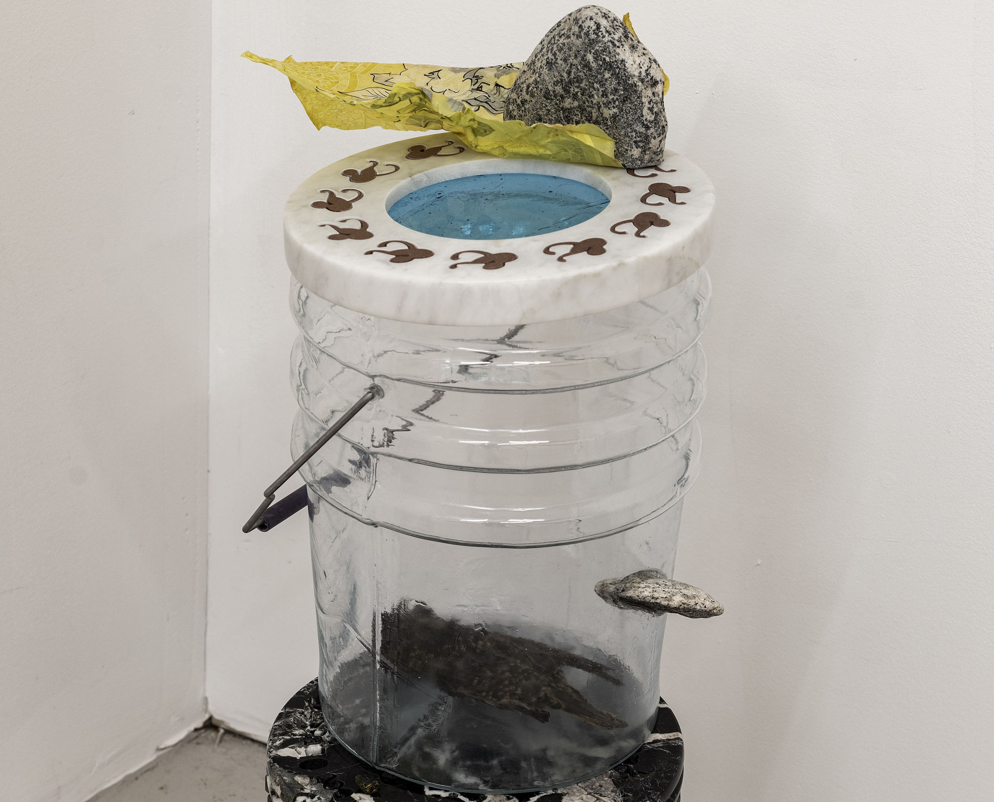 Catherine Telford Keogh Dust Gardens (&&& Arrested Cavity), 2025 Mold-blown glass (Leaktite™ 2-gallon white plastic pail), waterjet-cut Carrara marble, waterjet-cut terracotta porcelain, found diorite, steel rod, sandblasted glass tube, inherited Starling skin, stained glass, found landfilled tablecloth, table cloth dust after wiping, black ink tracing 16⅜ x 10¼ x 12¼ inches 41.7 x 26 x 31.1 cm