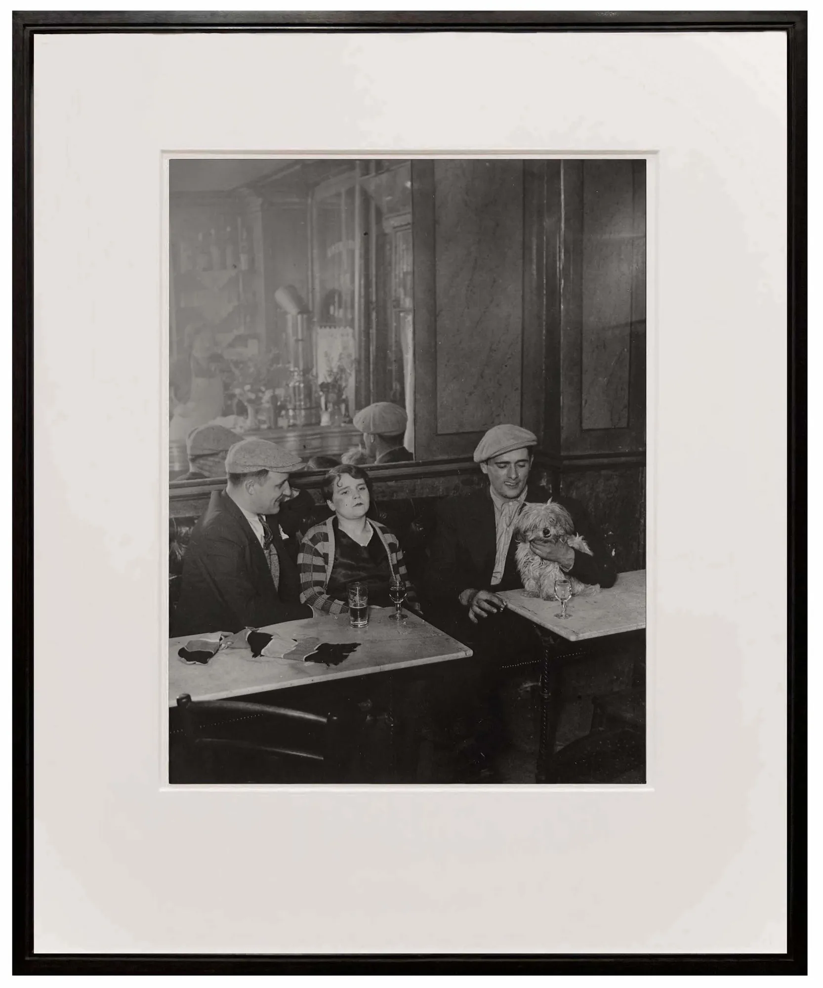 woman and two men at cafe from Paris de Nuit by Brassai