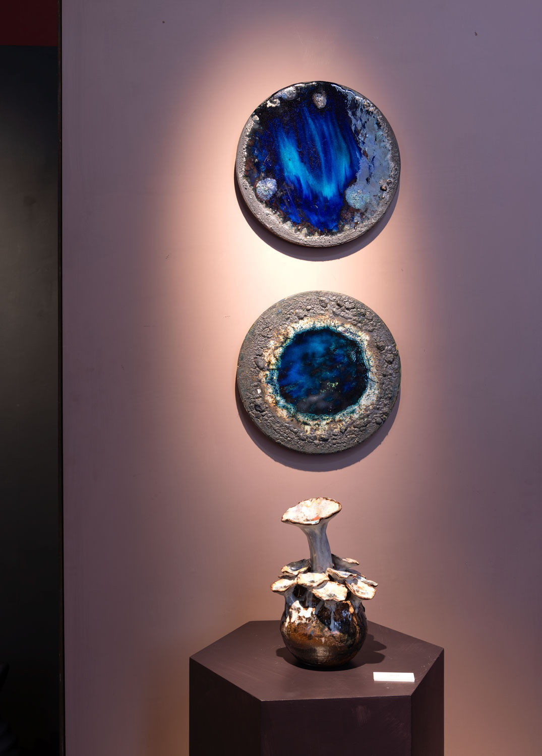 A 'Sea Flower' and two wall plaques by Lotte Glob.
