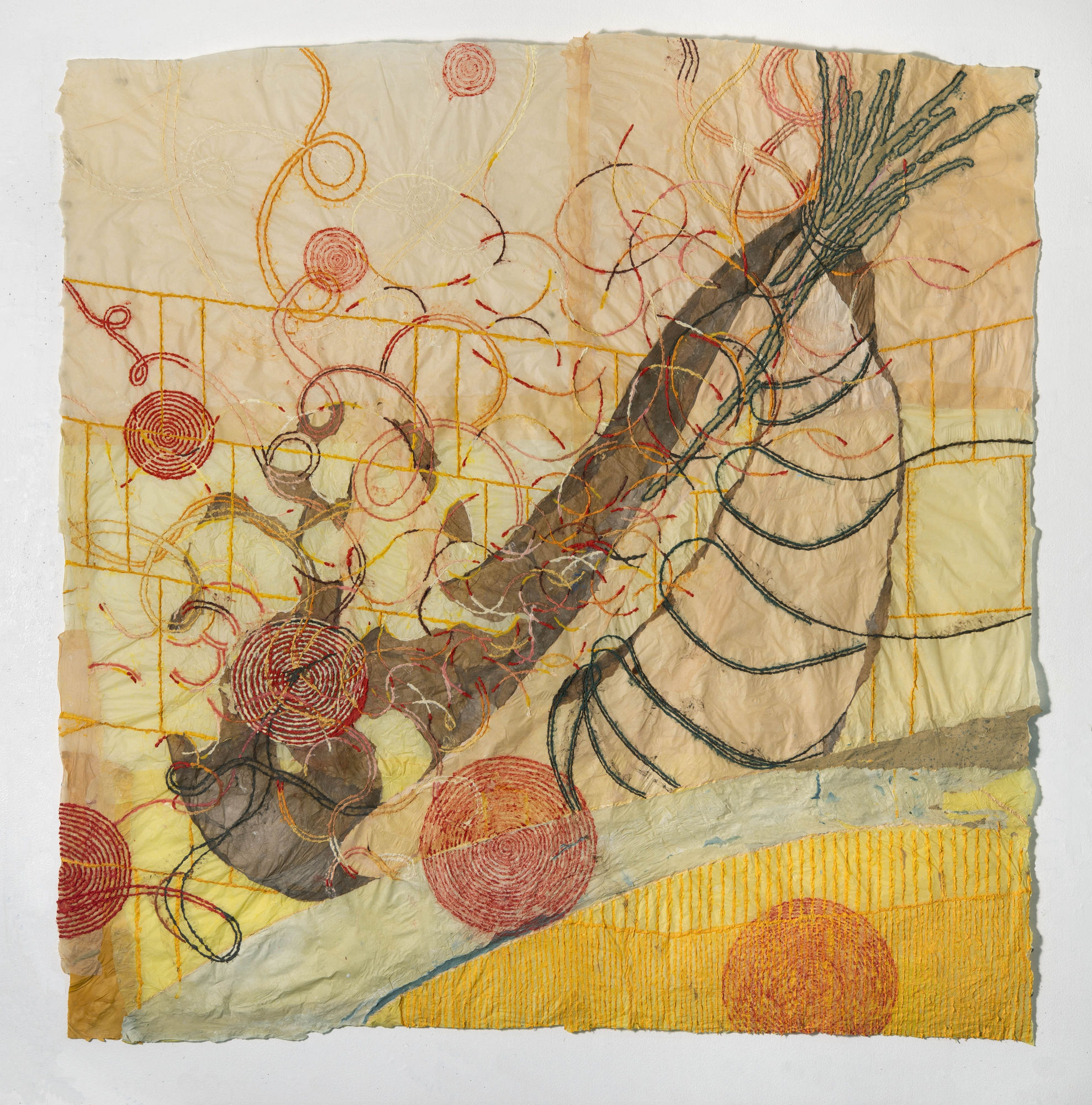 Nancy Cohen's "Public Market" done with paper pulp and handmade paper in various shades of yellow, orange, tan, blue and green. The piece depicts several design layers on the light orange paper. These designs are overlapping each other creating depth.