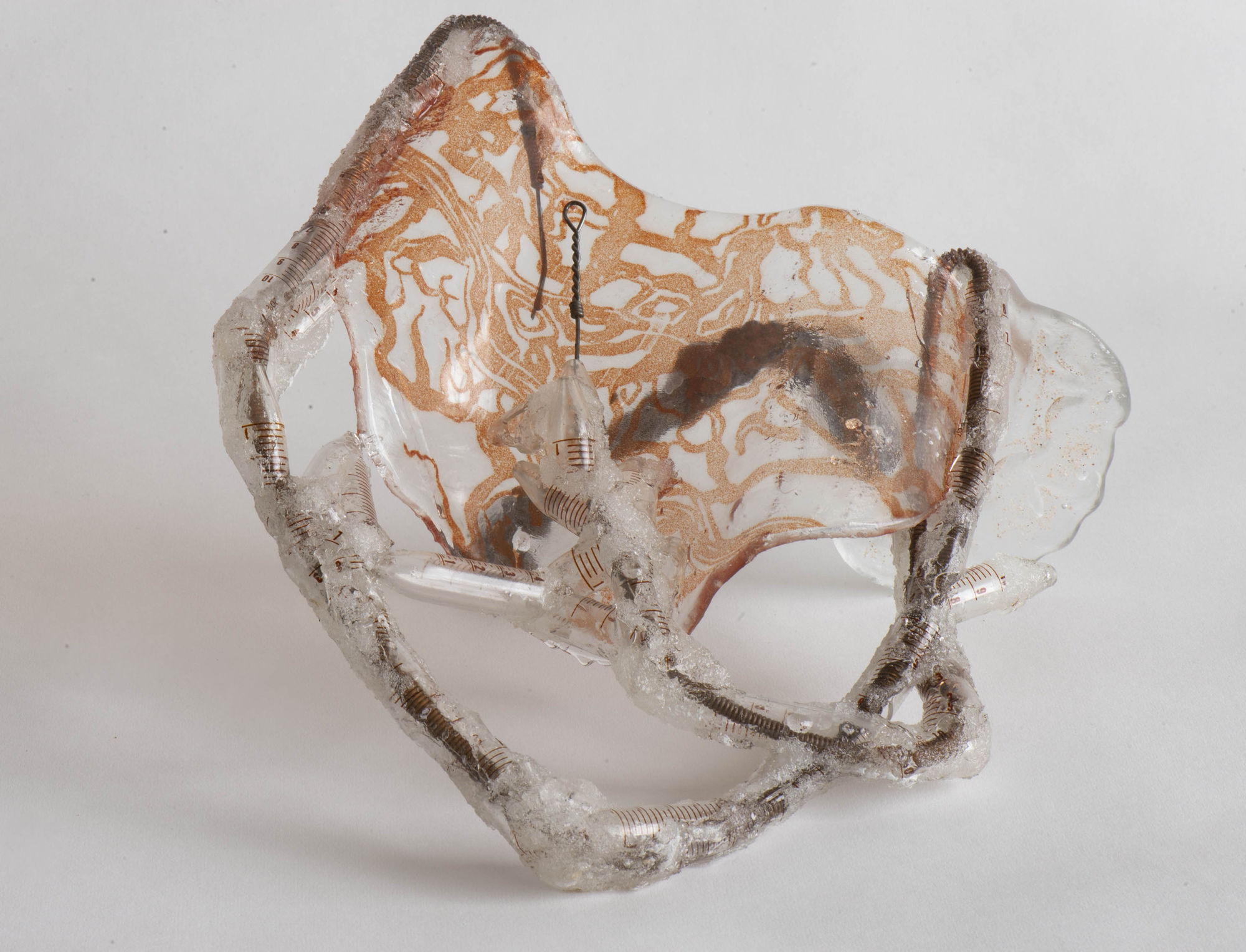 Nancy Cohen's "Intercoastal" art piece made from glass and metal. The glass has brown design patterns and metal wires have been enclosed inside the glass.