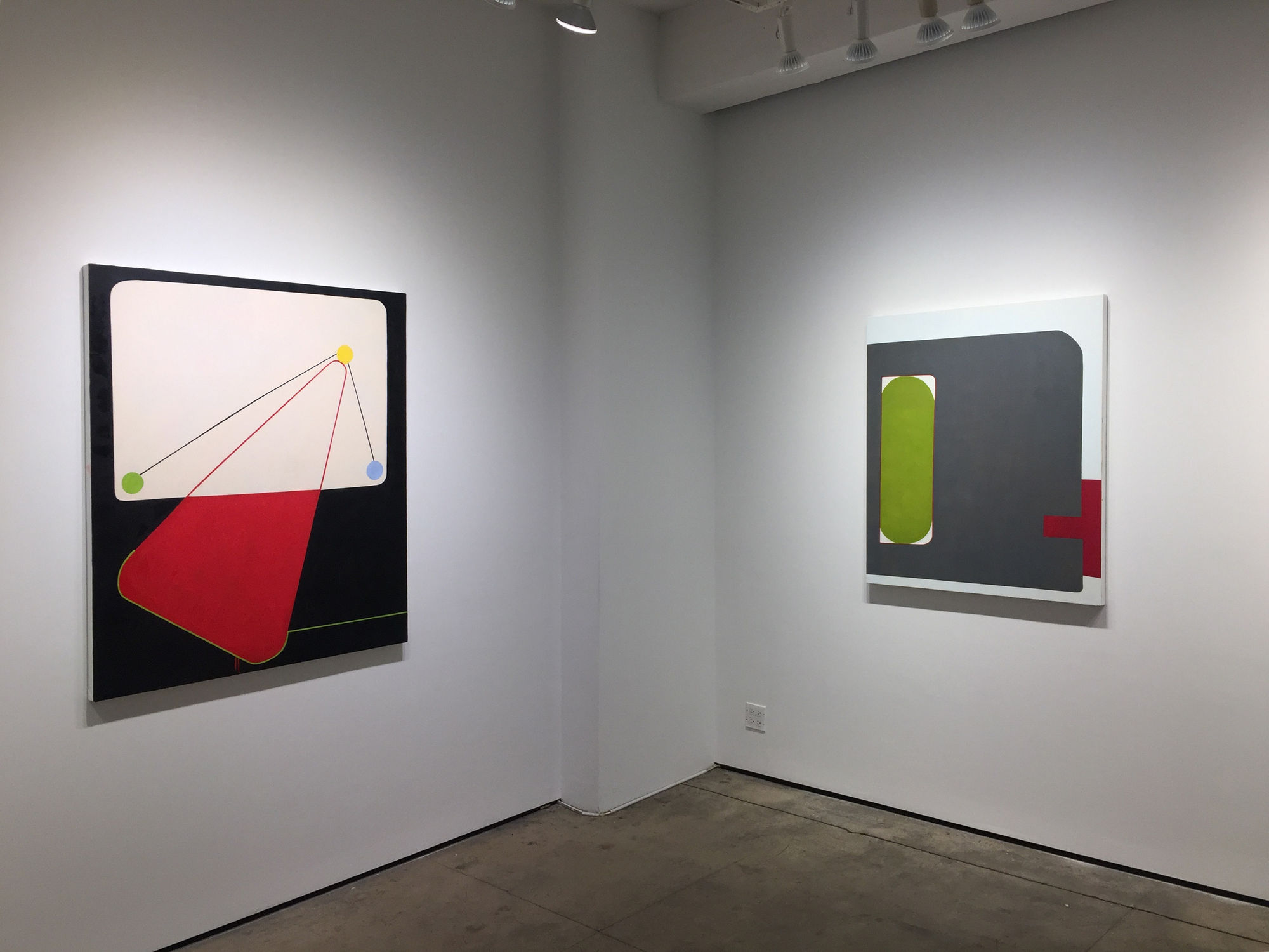 Gallery photograph of an installation featuring two abstract paintings on canvases in shades of gray, red, green, blue and yellow respectively.