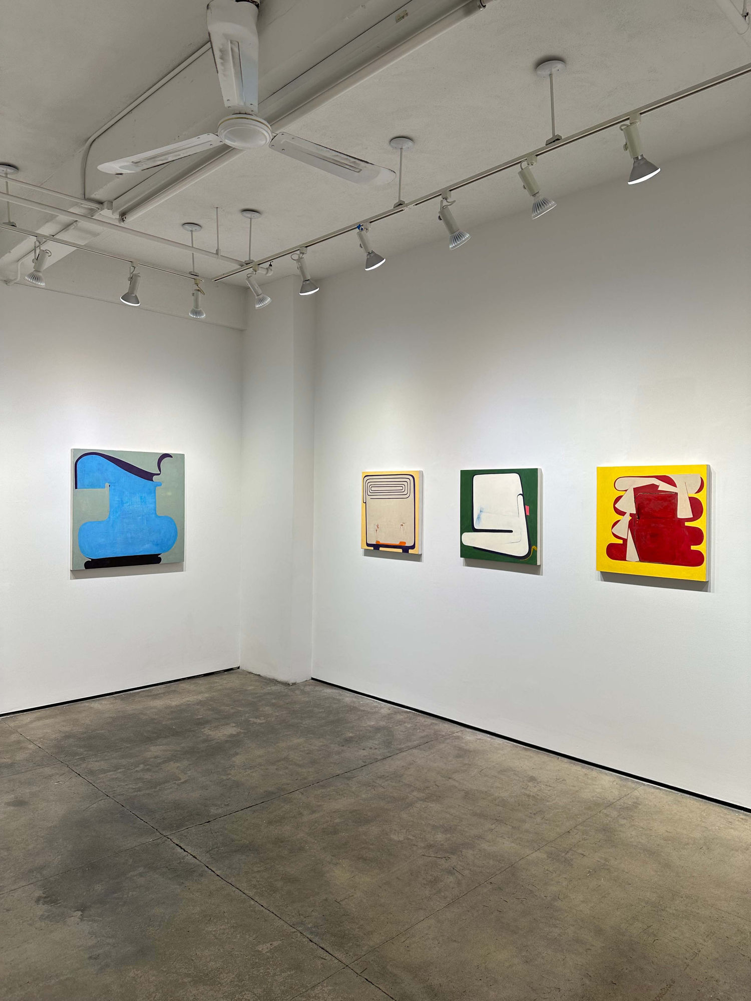 exhibition with four abstract paintings on the walls