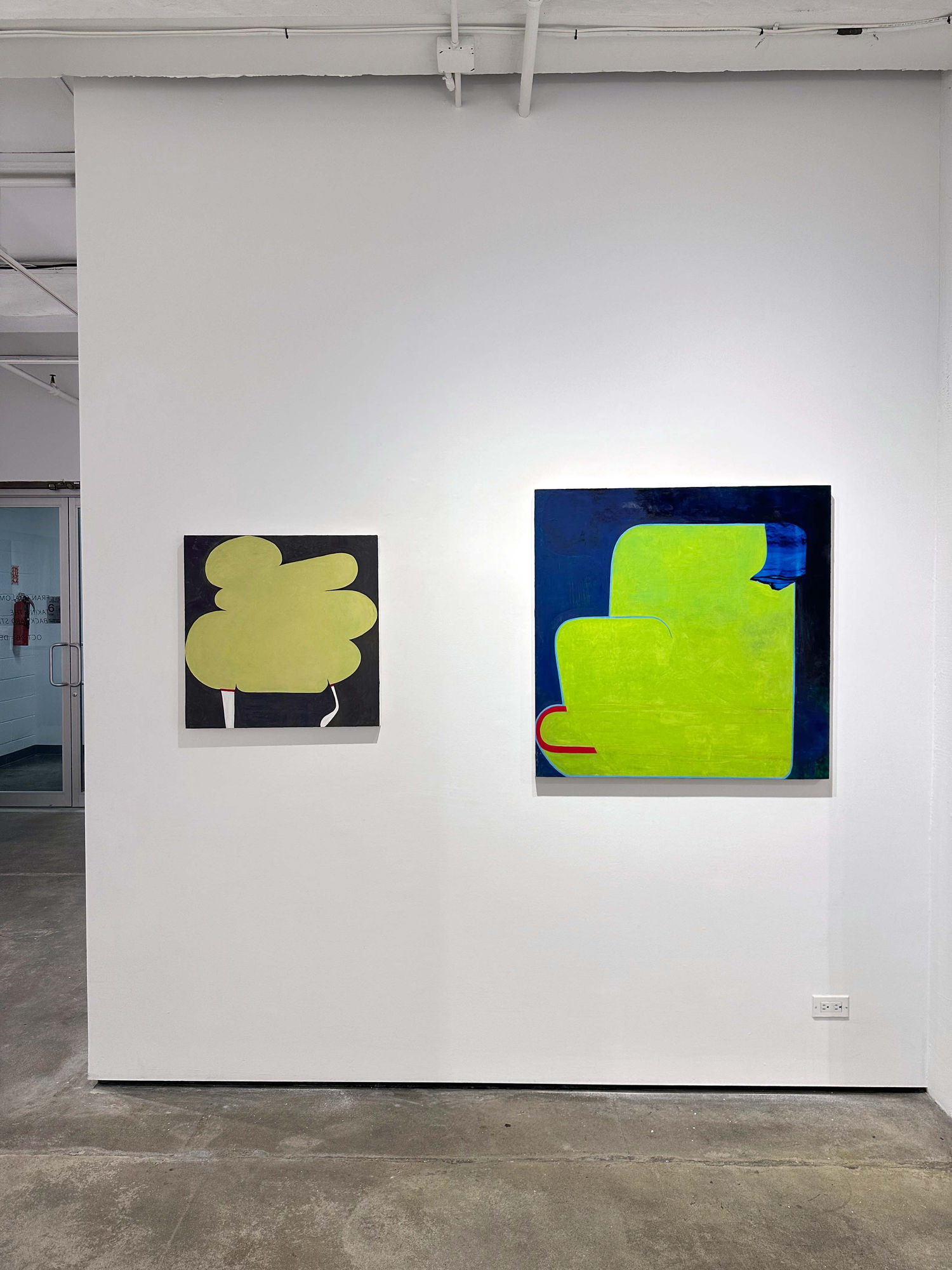 exhibition with two abstract paintings on the walls