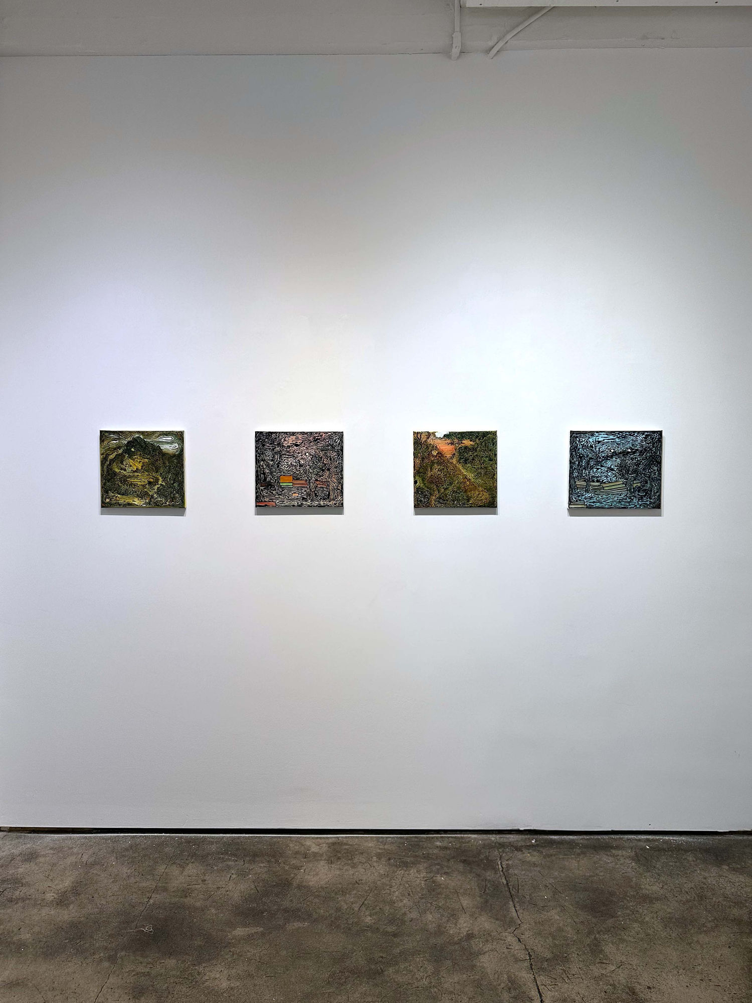 exhibition with four paintings of equal size on a wall