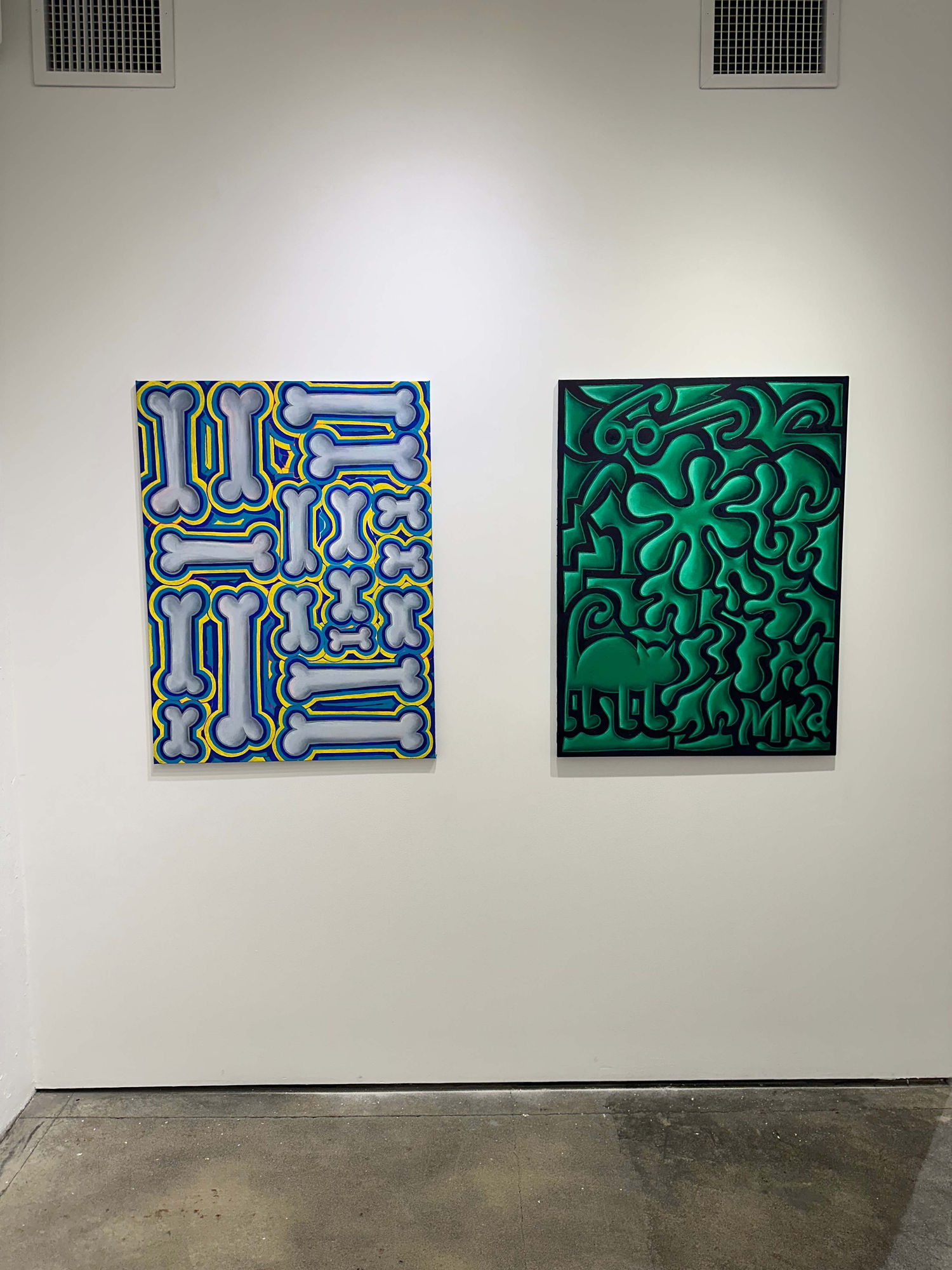 exhibition with two paintings on the wall