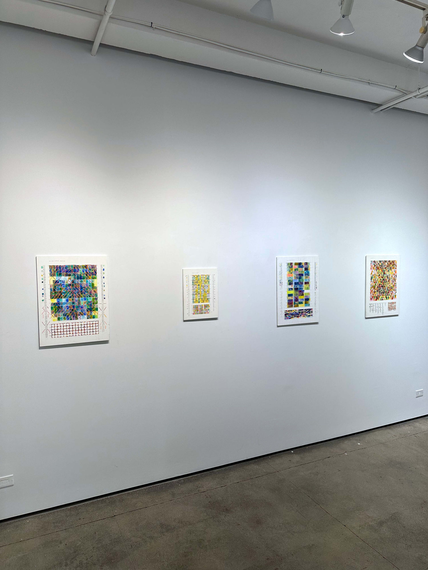 exhibition with four paintings next to each other 