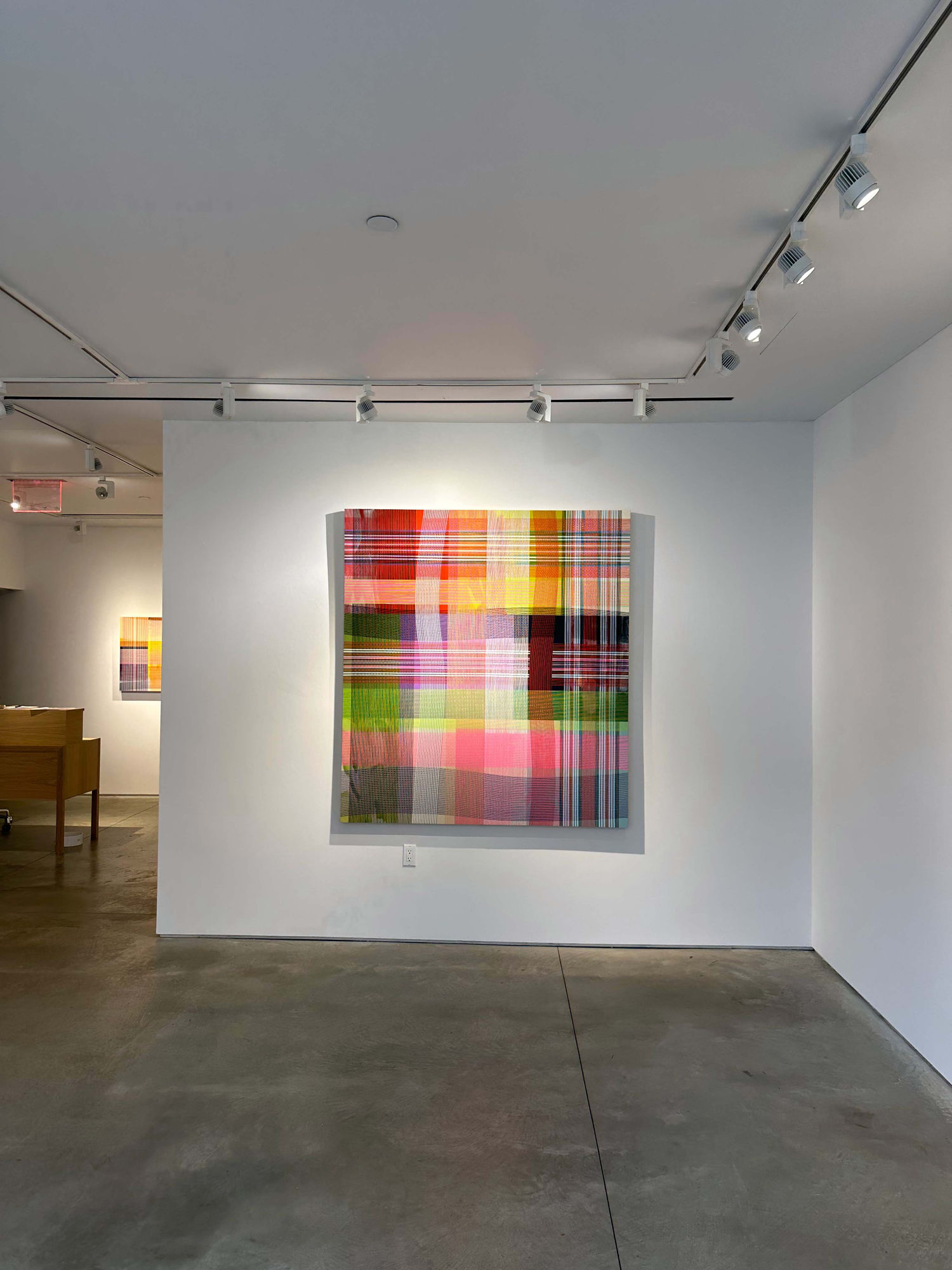photo of an installation with one abstract painting visible