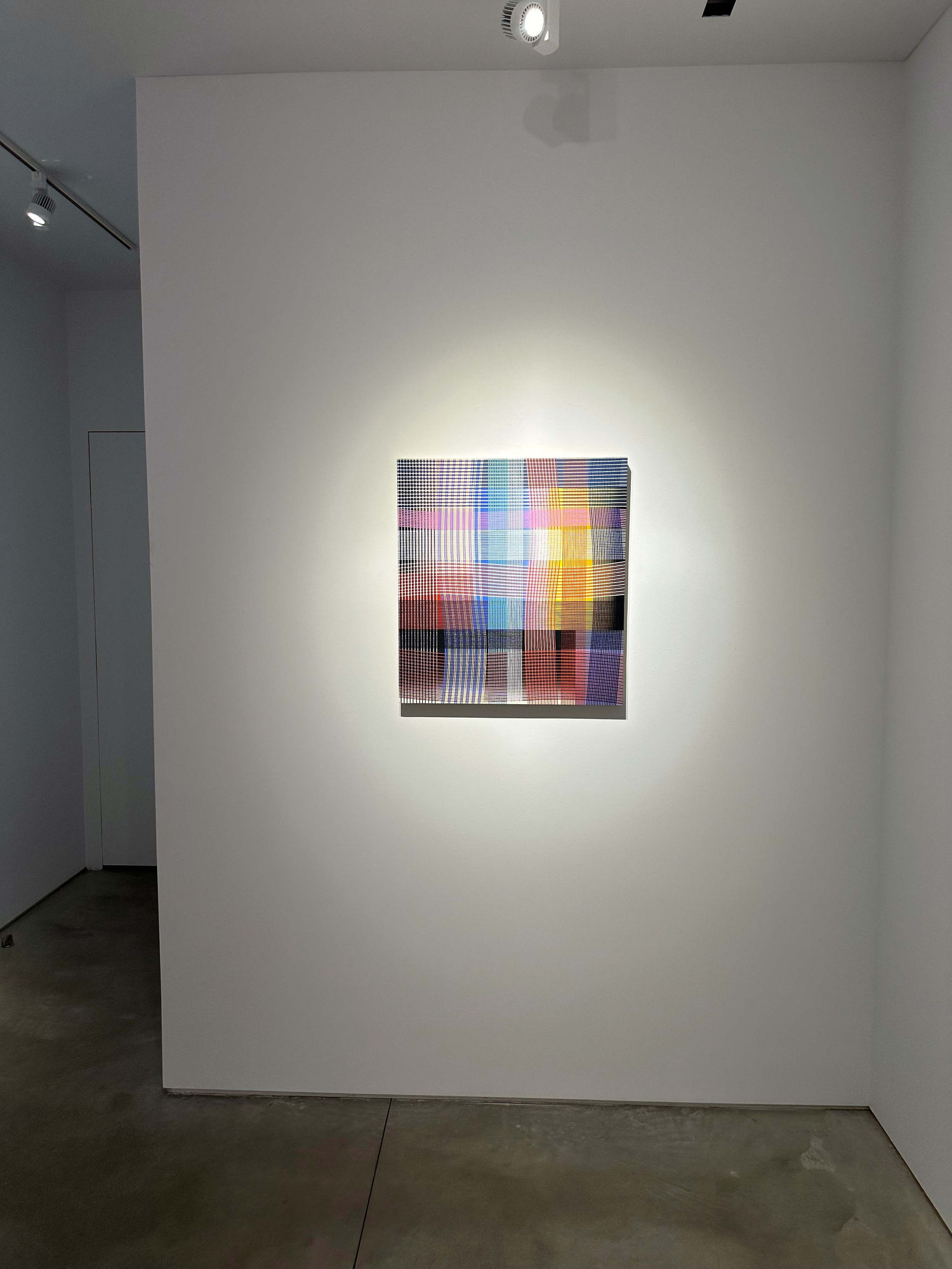 photo of an installation with one abstract painting visible