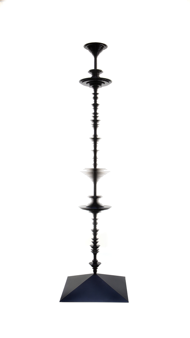 a sculpture by Elizabeth Turk of black aluminum discs layered and arranged to resemble a sound wave and a modernist abstraction