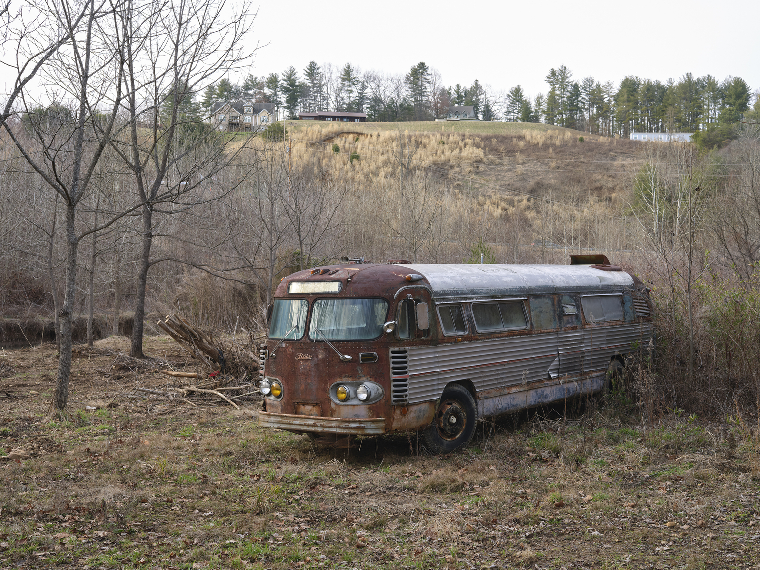 abandoned, rusted bus in landscape