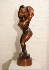 Wooden sculpture of a woman with slightly bent knees and looking into the distance at an angle. Her hands are reaching above her head.