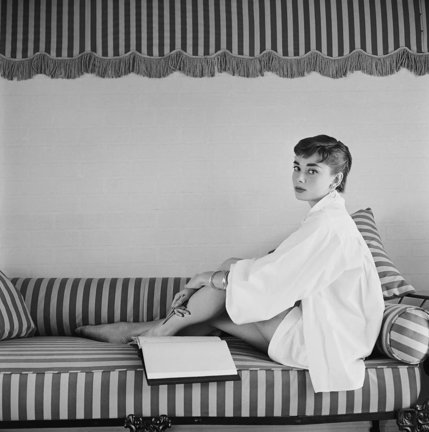 Audrey Hepburn on Striped Sofa