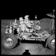 David Scott Drives the First Lunar Rover; Note Aerial Navigation Photographs;, Photographed by James Irwin, Apollo 15, July 26-August 7, 1971