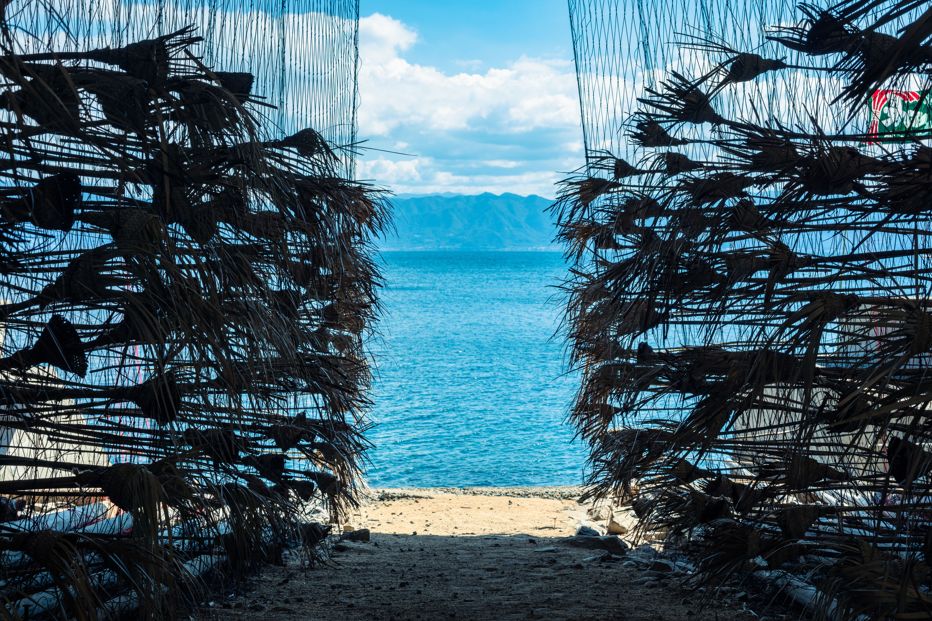 The artwork has the form of a frame that focuses the eye towards the view of the sea, the artwork...