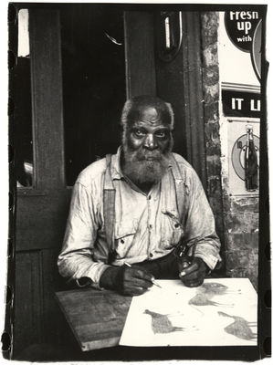 Black and white photograph of the African American artist Bill Traylor. Photograph by Charles Shannon. Monroe Street. Montgomery, Alabama, ca. 1940-43