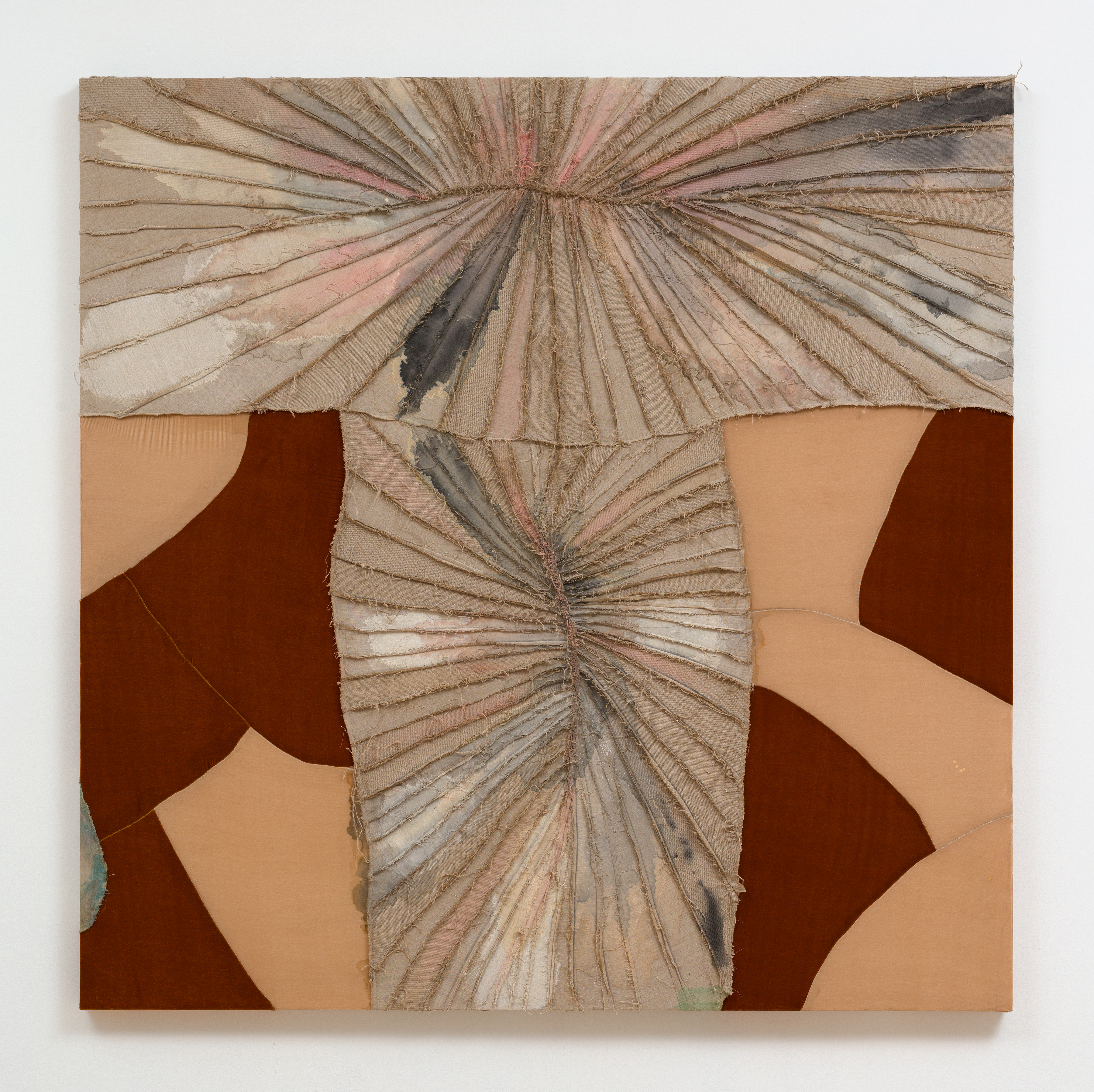 A stretched textile artwork by Elaine Stocki of multicolored sections of fabric sewn together.