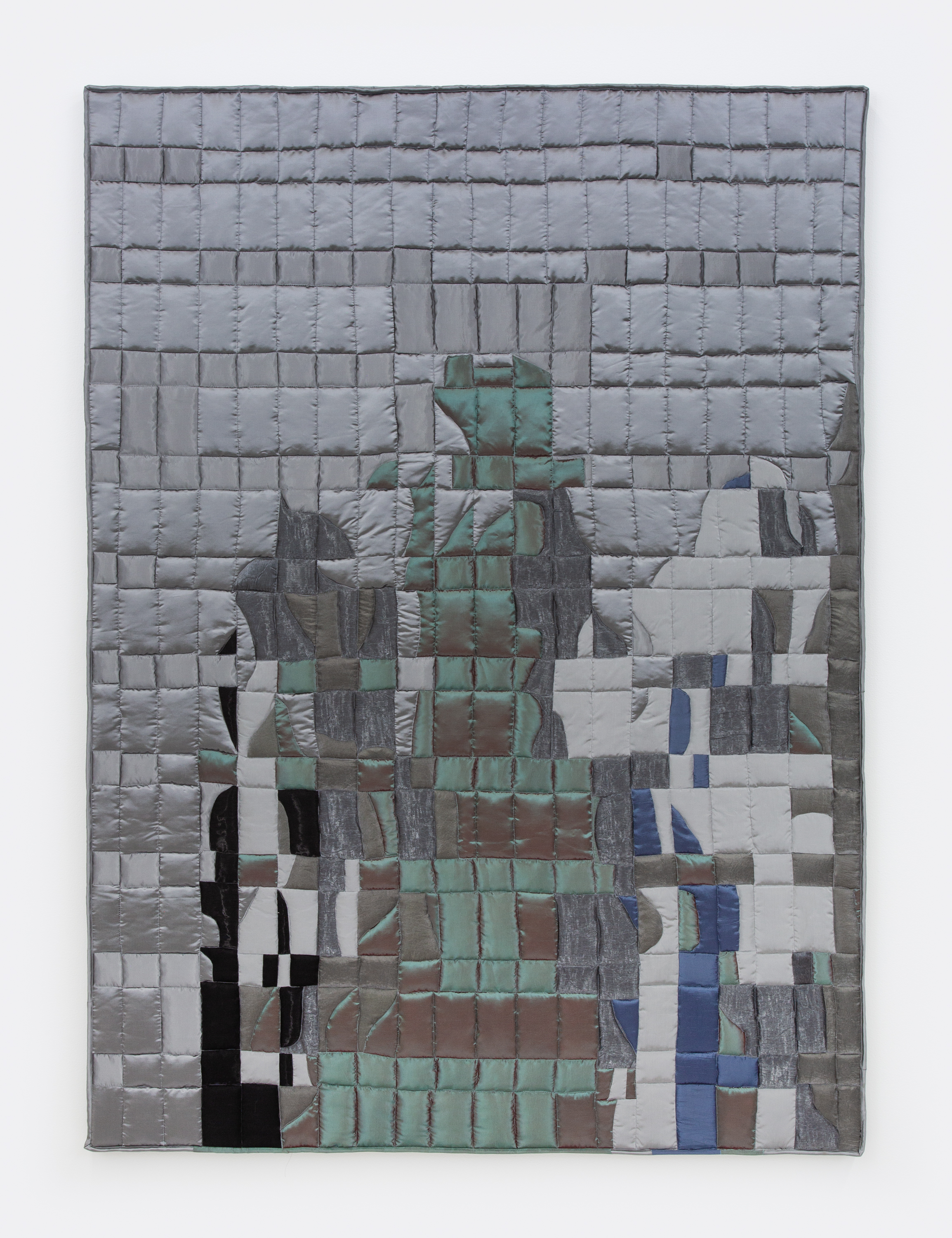 A stretched textile work by Anne Libby of silver, green and burgundy shapes sewn into a grid. 