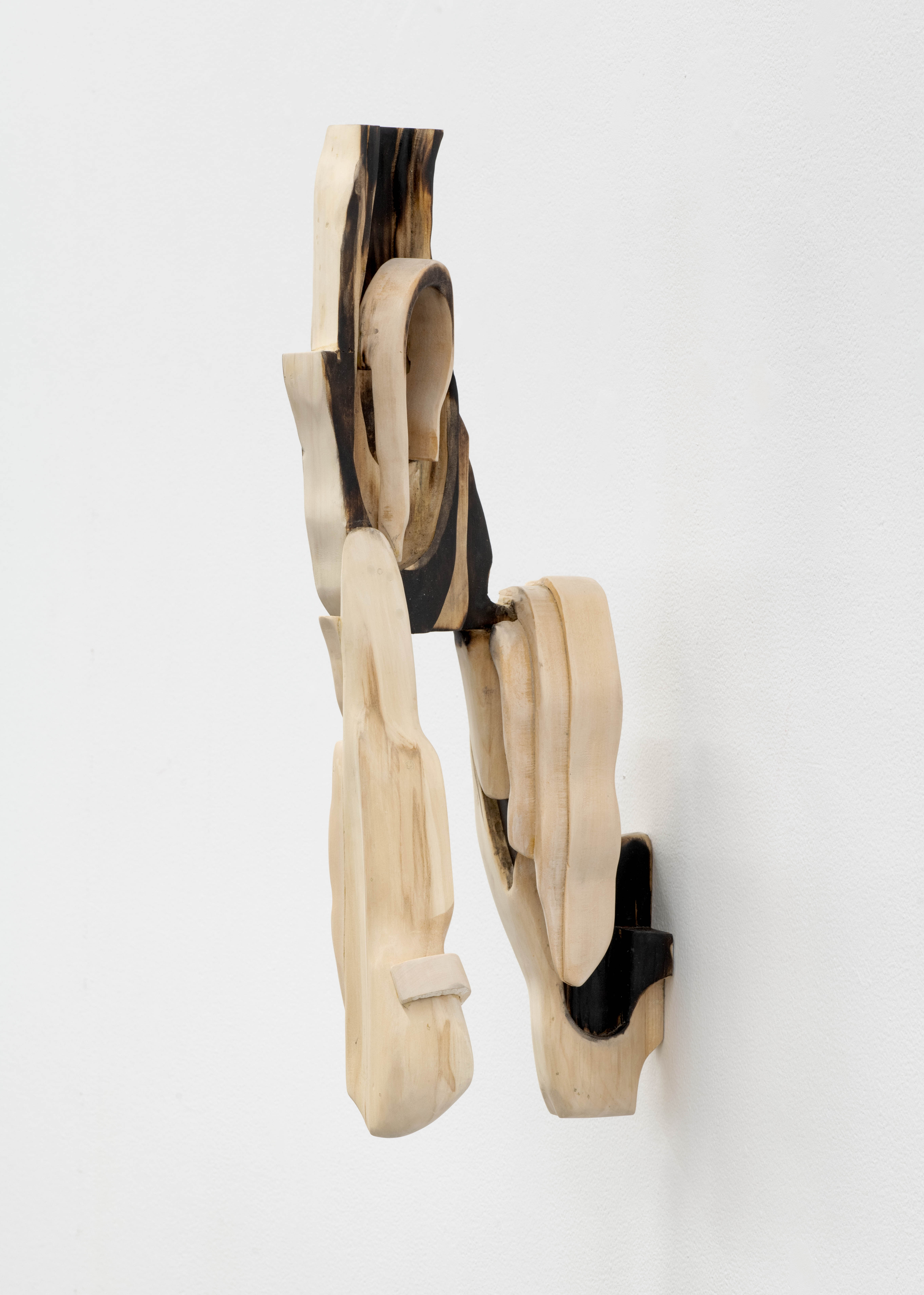 A wall mounted sculpture by David Armstrong Six of abstract geometric pieces of wood adhered together. 