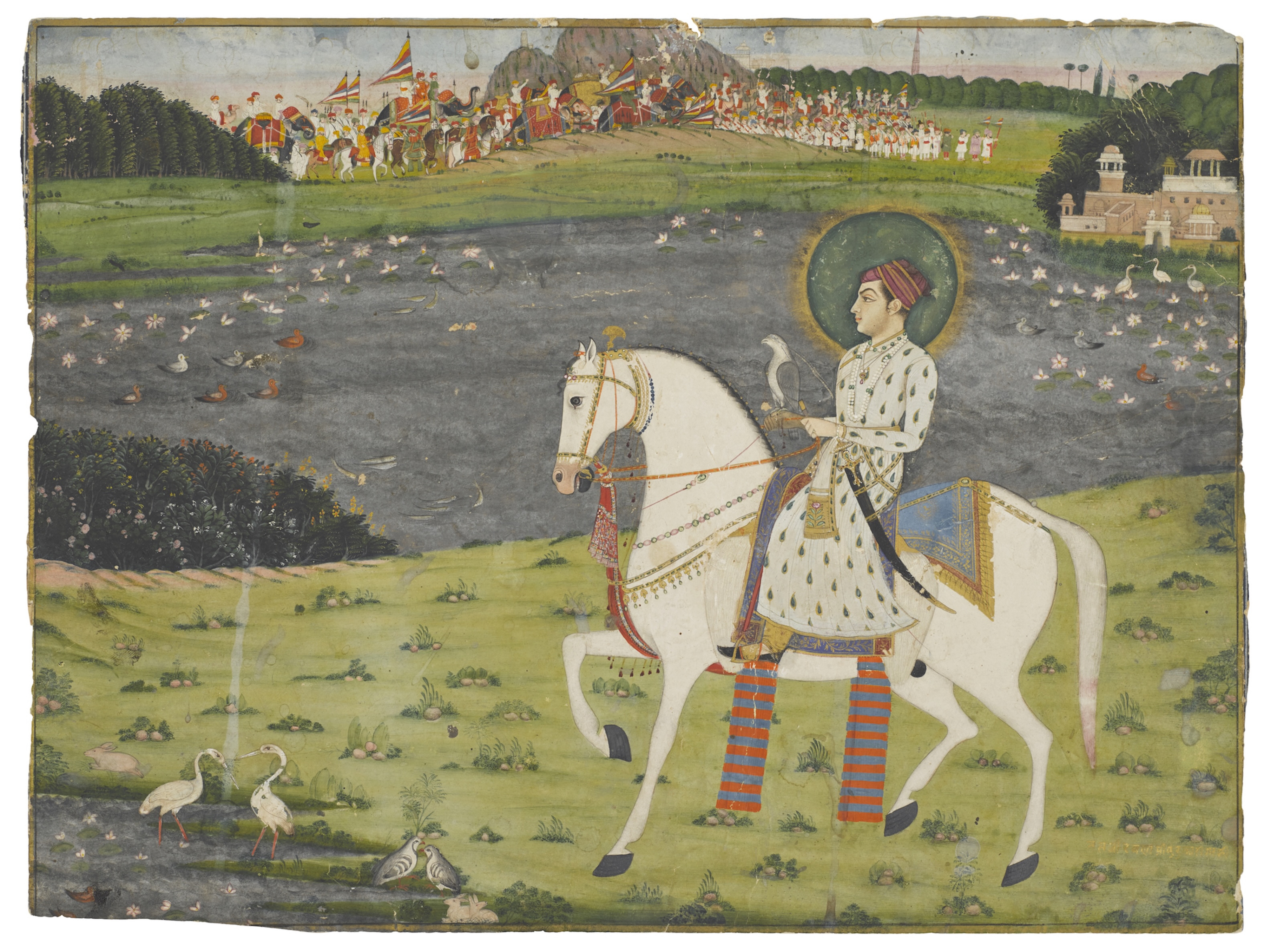 A young prince dressed in a long white jama patterned with green leaves outlined in gold is riding past a lake filled with lotuses and ducks