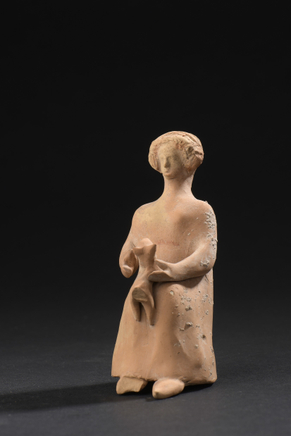 Greek sculptural group of seated woman and puppy, 4th century BC