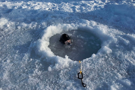 Louie Palu, A US Navy diver assists a team from the Arctic Submarine Laboratory recover a torpedo fired from a nuclear-powered fast-attack submarine during weapons testing near a military camp constructed on a sheet of ice in the Arctic Ocean, 2018