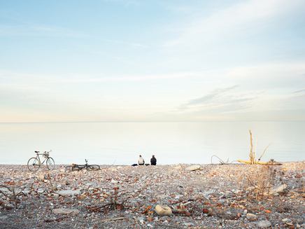 Robert Burley, Cyclists on the shoreline of the Endikement, Tommy Thompson Park, Toronto, 2020