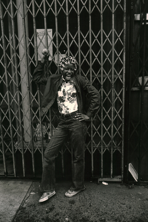 Jill Freedman, Untitled [Girl in hair rollers with baseball], circa 1980