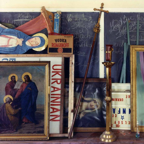 Color photo of a storage space in a church, showing a jumble of religious paraphernalia.
