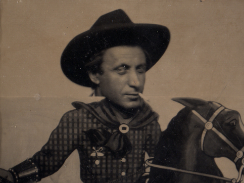 Arshile Gorky posing in a cowboy cut-out at an amusement park on the beach in San Francisco, 1941.