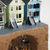 miniature sculpture of 3 victorian houses with a hole underground