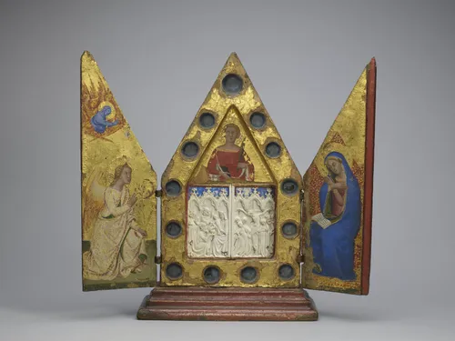 Reliquary triptych with the Annunciation, Saint Ansanus and plaques of the Adoration of the Magi and the Crucifixion, painted by Bartolo di Fredi (c. 1330-1410), Tuscan (Siena) and French (Ivory plaques), c. 1370 (triptych), c.1350-70 (ivory plaques) Tempera on panel with gilded and polychromed ivory h. 35.5 × w. 38.5 cm (open)