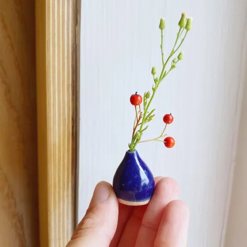 miniature ceramic pot in blue with berries