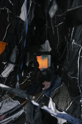 Marcin Dudek, Inspire.People.Motion., 2020, Used textiles, thread, wood, steel, video monitor. Detail. Photo: Damon De Backer.