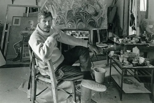 Photograph of John Craxton in his studio with portrait of Christopher Cone in background