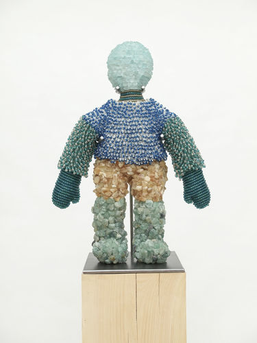 Jeffrey Gibson, Doll 1, 2020, acrylic felt, glass beads, artificial sinew, citrine, florite, aquamarine glass stones, steel rod, nylon thread, polyester fiber fill, steel support, wood base, 75 × 23 × 13 1/2".