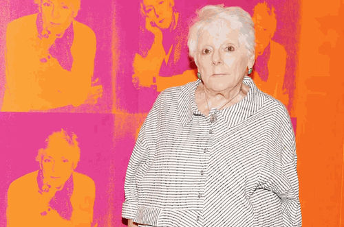 Linda Nochlin, standing in front of Deborah Kass’s 1997 work Orange Disaster (Linda Nochlin). Photo: Clint Spaulding/Patrick McMullan. Painting: © 2017 Deborah Kass / Artists Rights Society (ARS), New York