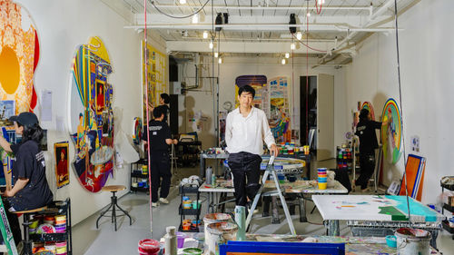 The artist Tomokazu Matsuyama in his Brooklyn studio with members of his team and works in progress (matzu.net)