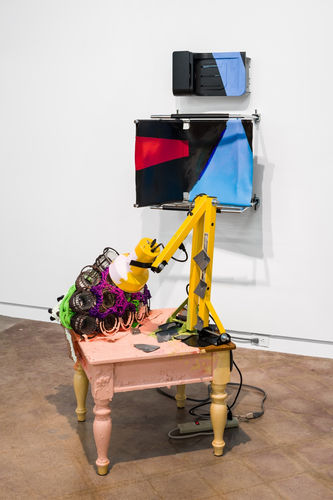Jessica Stockholder, And Server, 2016. Table, garden light fixtures, rope, acrylic and enamel paint, industrial light xture, plastic parts, hardware, metal mesh, papier mâché, taupe-colored power bar, parts from printer, and hard drives. 79 x 75 x 43 inches.