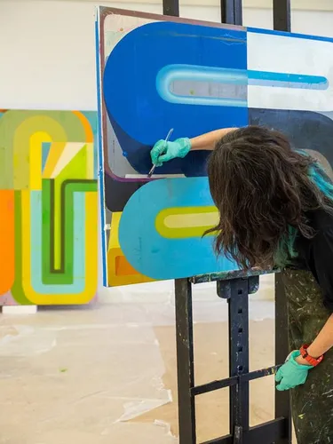 Deborah Zlotsky painting in her studio.
