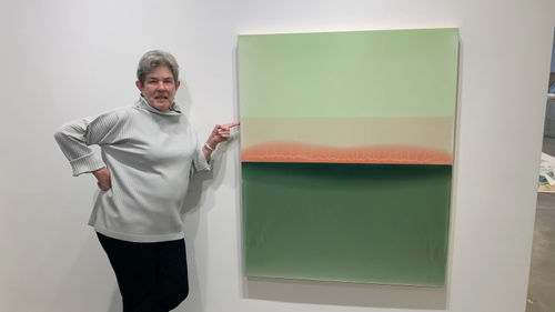 Kathryn Markel with an abstract art painting by Susan English.