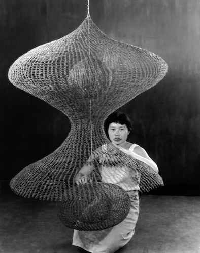 Ruth Asawa with one of her hanging looped-wire sculptures in 1957. Photograph by Imogen Cunningham
