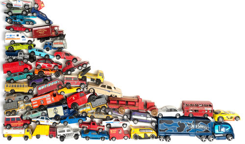 Athol Whitmore piece, showing a large stack of toy cards piled on top of one another, a white background reveals itself as less cars are stacked to the right of the image.